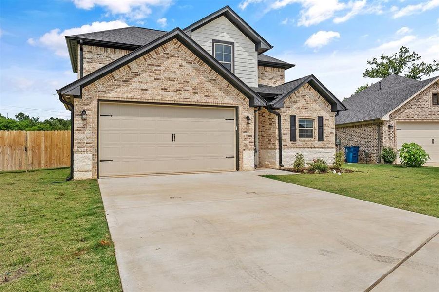 Front exterior of a new home in , Lindale, TX, highlighting curb appeal (Image 17).