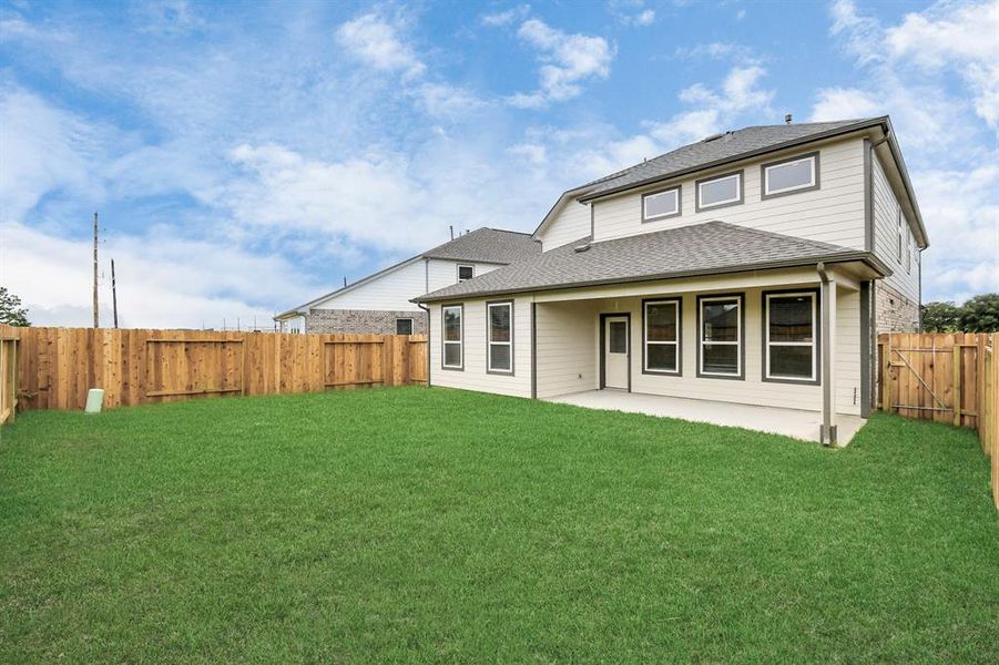 Discover the charm of this spacious backyard featuring a delightful covered patio. With ample room for both play and relaxation, it's the perfect outdoor haven.