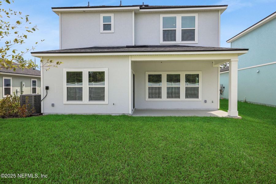 Front exterior of a new home in Cordova Palms, St. Augustine, FL, highlighting curb appeal (Image 18).