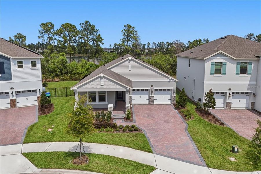 Front exterior of a new home in Waterleigh, Winter Garden, FL, highlighting curb appeal (Image 23).
