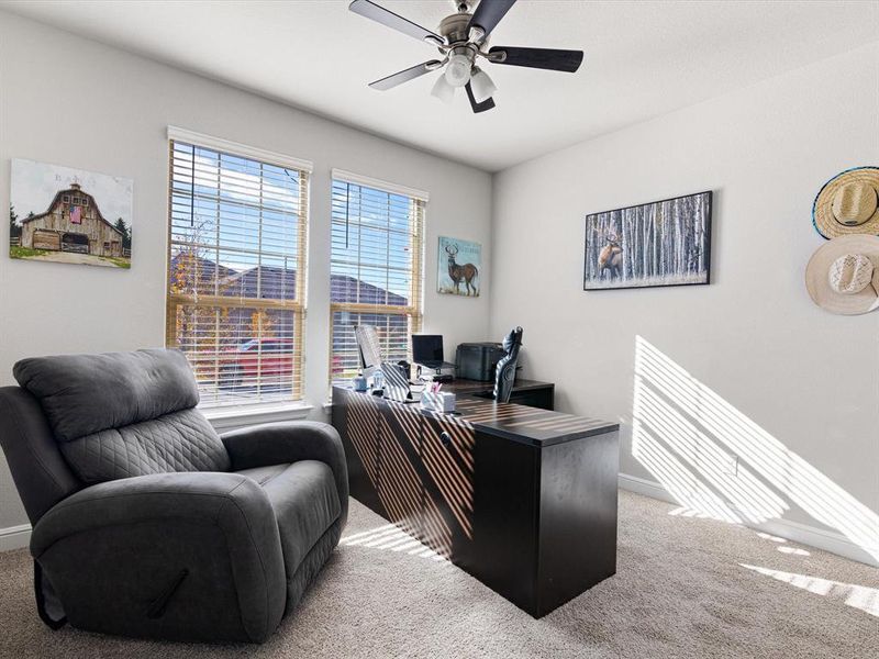 Carpeted home office with ceiling fan