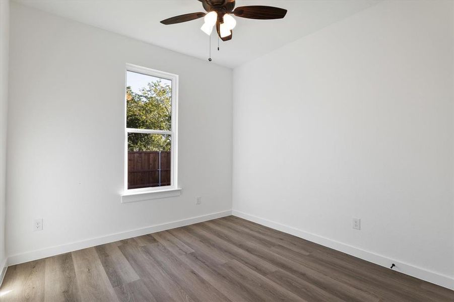 Unfurnished room with wood-type flooring and ceiling fan