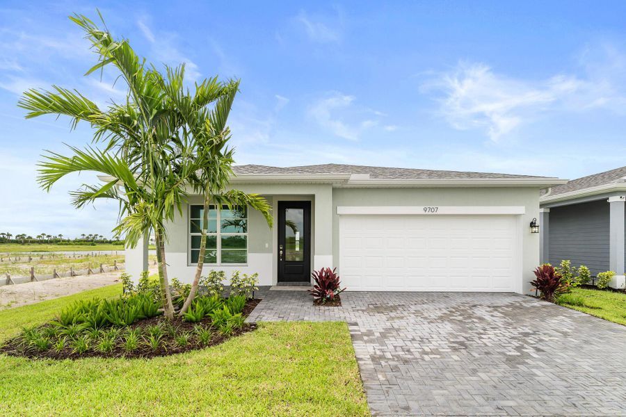 Front exterior of a new home in Tradition - Kenley, Port St. Lucie, FL, highlighting curb appeal (Image 1). Front exterior of a new home in Tradition - Kenley, Port St. Lucie, FL, highlighting curb appeal (Image 1).