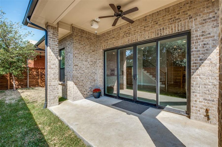 View of private exterior with a yard, patio area and ceiling fan