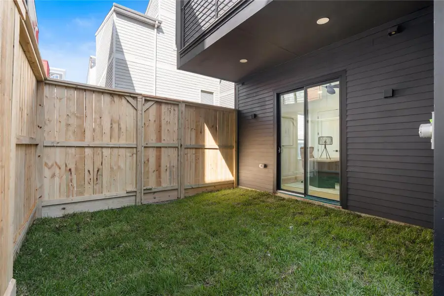 A rare luxury in urban living—this private yard extends the functionality of the first-floor suite, offering a quiet patch of green ideal for morning coffee, weekend lounging, or a four-legged companion. Framed by clean fencing and sheltered by modern architecture, it’s a compact outdoor escape with endless A rare luxury in urban living—this private yard extends the functionality of the first-floor suite, offering a quiet patch of green ideal for morning coffee, weekend lounging, or a four-legged companion. Framed by clean fencing and sheltered by modern architecture, it’s a compact outdoor escape with endless