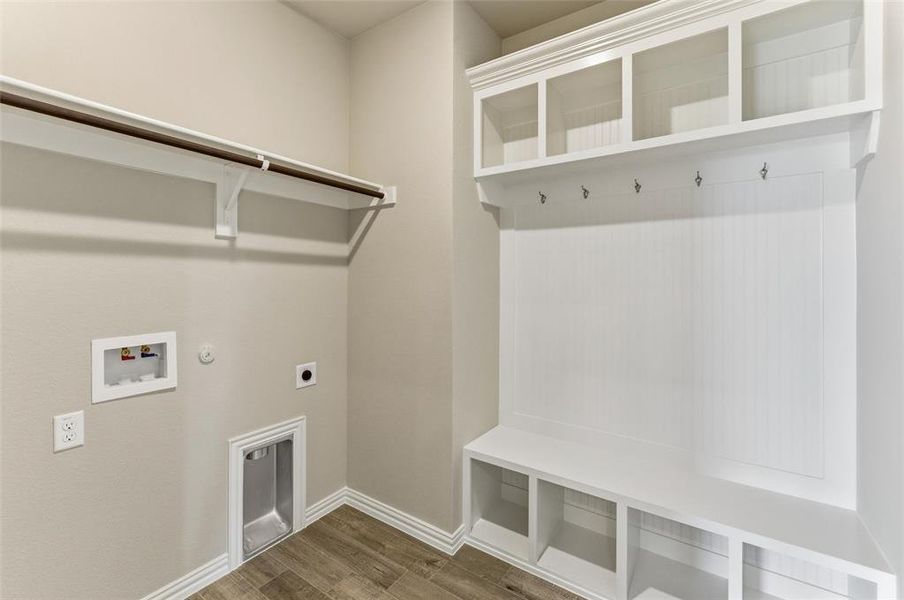 Laundry room featuring hookup for a gas dryer, wood finished floors, hookup for an electric dryer, and hookup for a washing machine