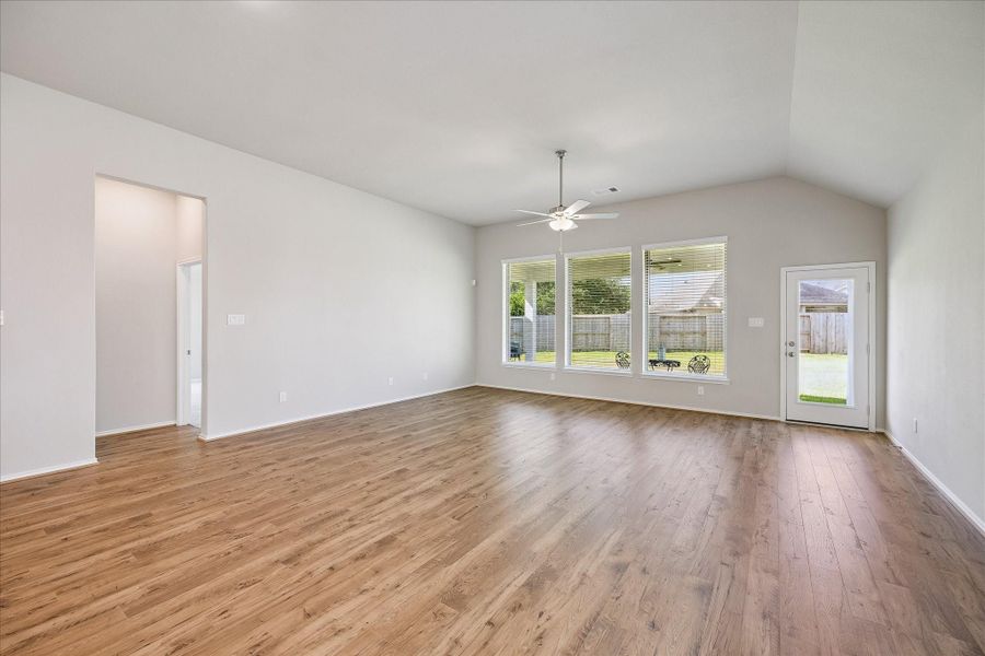 Walk straight ahead and you come into the spacious living and dining areas. The room is accented with luxury wood plank flooring and large windows for natural light. There is a ceiling fan to keep you comfortable as well.
