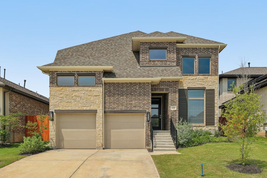 View of front of home with driveway, a shingled roof, a garage, brick siding, and a front yard View of front of home with driveway, a shingled roof, a garage, brick siding, and a front yard