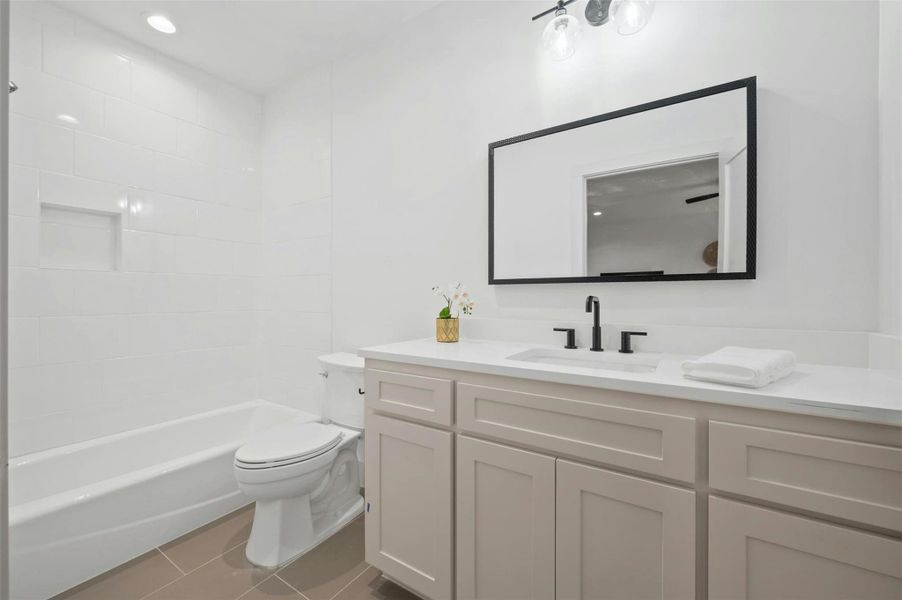 The studio's full bathroom provides a beautiful contemporary vanity and a shower/tub combo.