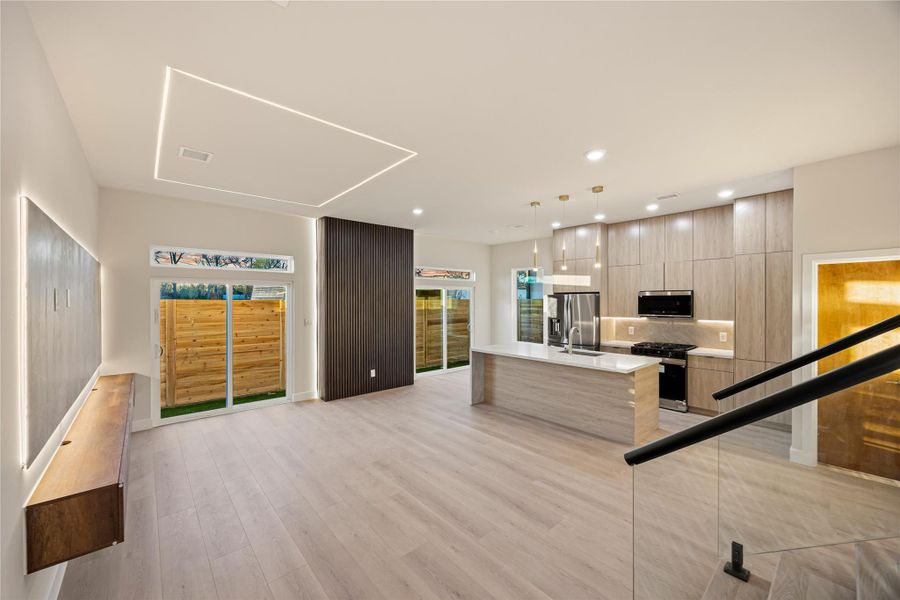 Unfurnished living room featuring light wood finished floors and recessed lighting