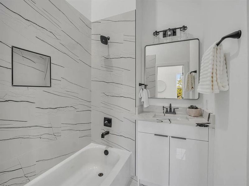 Bathroom with shower / bath combination and vanity