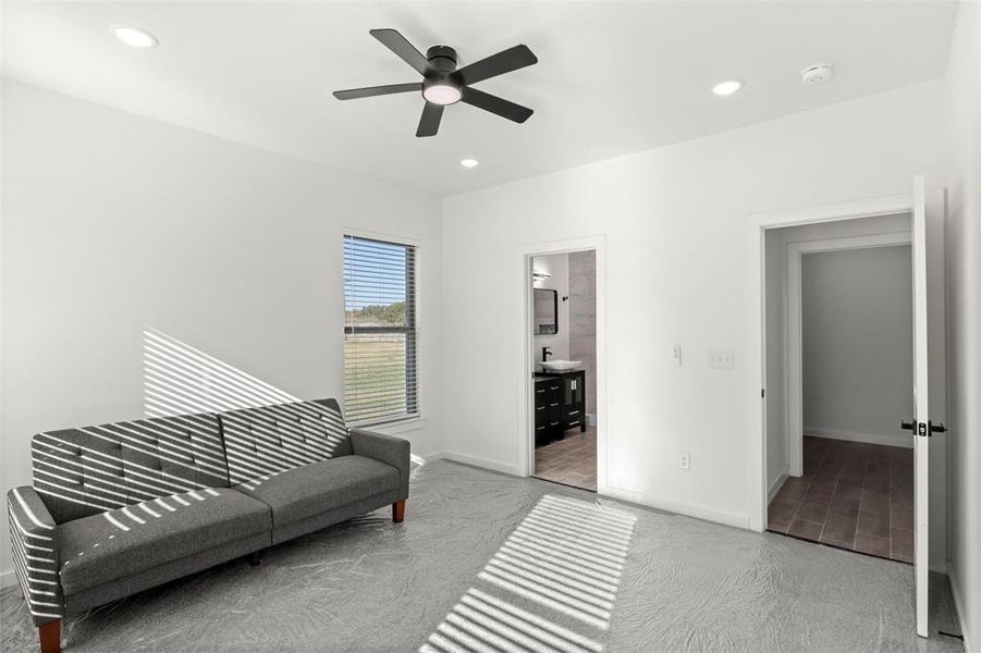Sitting room featuring light colored carpet, recessed lighting, and ceiling fan