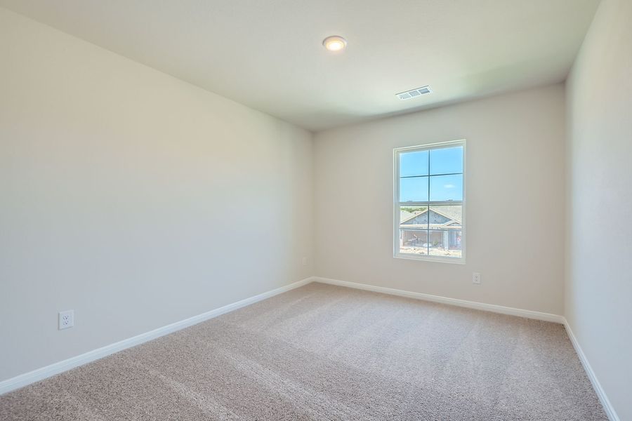 A room with a window and carpet.