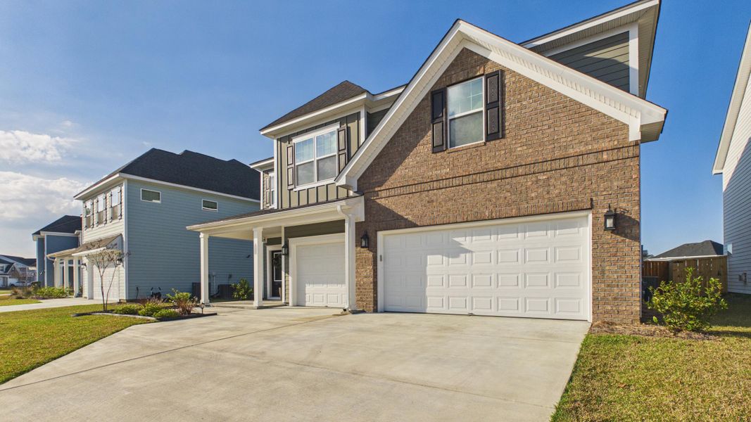 Front exterior of a new home in Hewing Farms, Summerville, SC, highlighting curb appeal (Image 27).