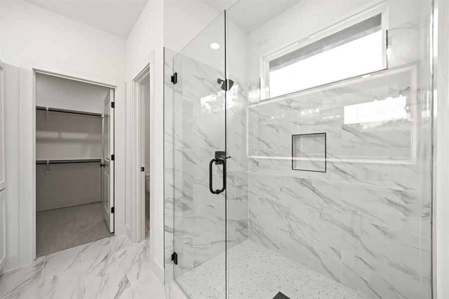 Full bath with a marble finish shower, a spacious closet, marble finish floors, and recessed lighting Full bath with a marble finish shower, a spacious closet, marble finish floors, and recessed lighting
