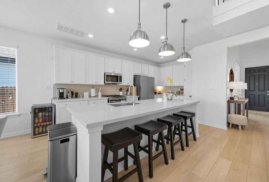 Kitchen with light wood-style floors, white cabinetry, tasteful backsplash, and recessed lighting Kitchen with light wood-style floors, white cabinetry, tasteful backsplash, and recessed lighting