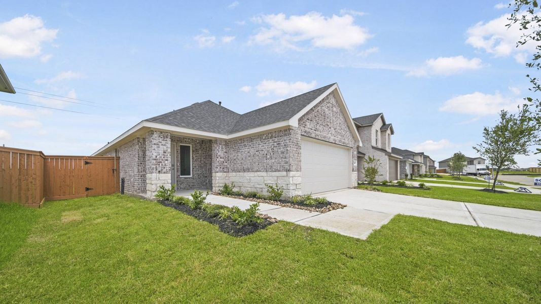 Front exterior of a new home in Sunterra, Katy, TX, highlighting curb appeal (Image 19).
