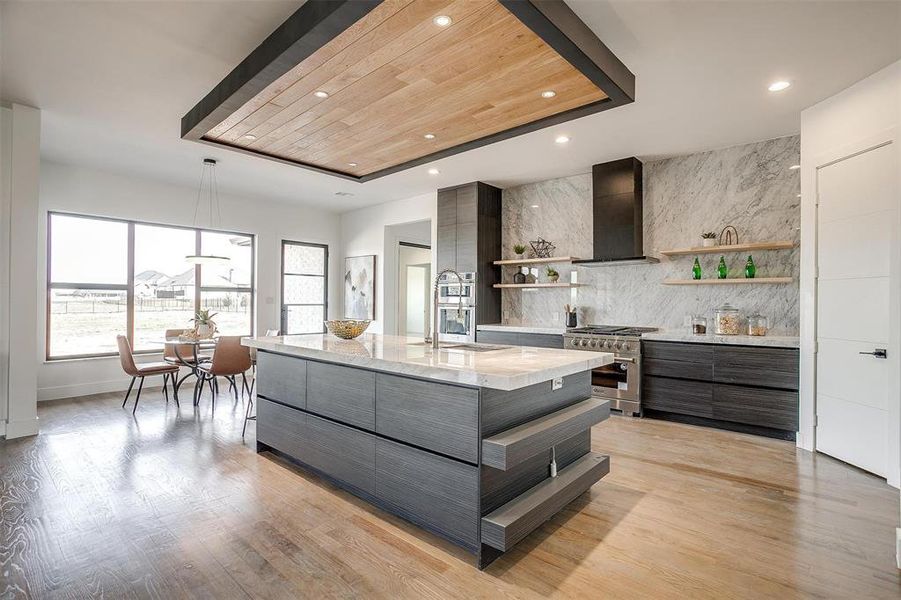 Kitchen with high end stove, modern cabinets, and open shelves