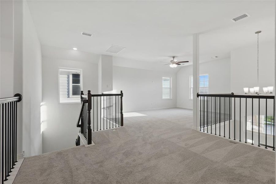 Hall featuring an upstairs landing, carpet flooring, and baseboards Hall featuring an upstairs landing, carpet flooring, and baseboards