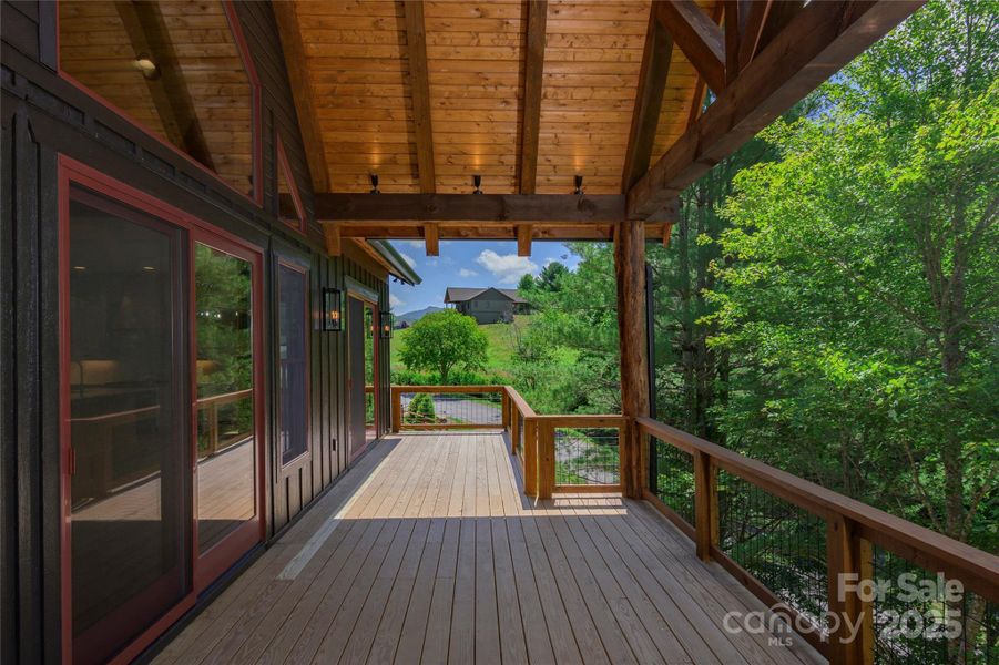 Over 1,200 square feet of outdoor space including main level porte-cochere, covered porches with majestic, private mountain & neighborhood pond views