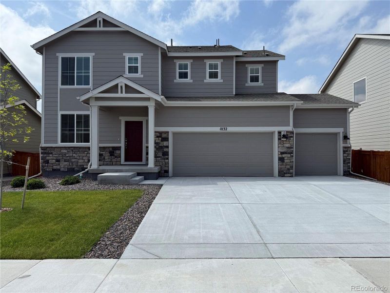 Front exterior of a new home in Hidden Valley Farm, Severance, CO, highlighting curb appeal (Image 1).