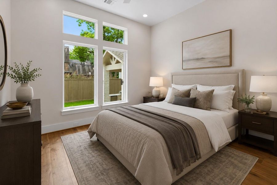 The first floor guest suite offers a peaceful retreat with warm oak flooring and expansive windows that fill the space with natural light.  Complete with a connected full bathroom, this private suite provides the perfect blend of comfort and convenience for over night guests, multigenerational living or a live in nanny. Virtually staged to illustrate furnishing possibilities