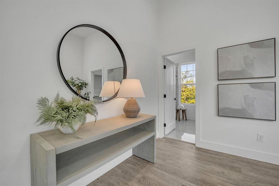 Hall with light hardwood / wood-style flooring