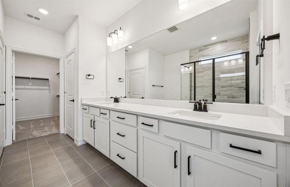 Modern owner's bath with dual vanities and a spacious shower *Real home pictured Modern owner's bath with dual vanities and a spacious shower *Real home pictured