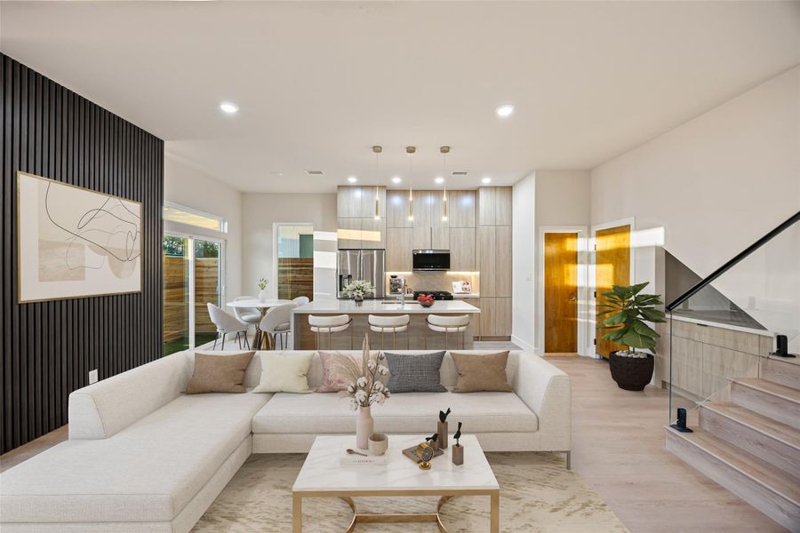 Living area with stairway, light wood finished floors, and recessed lighting