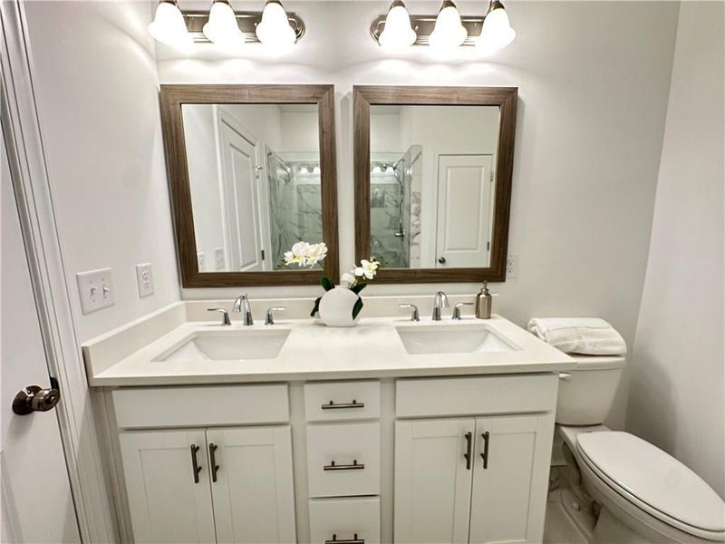 Owners Bathroom with quartz countertops, dual sinks and framed mirrors *photos are from the Magnolia model at different home site*