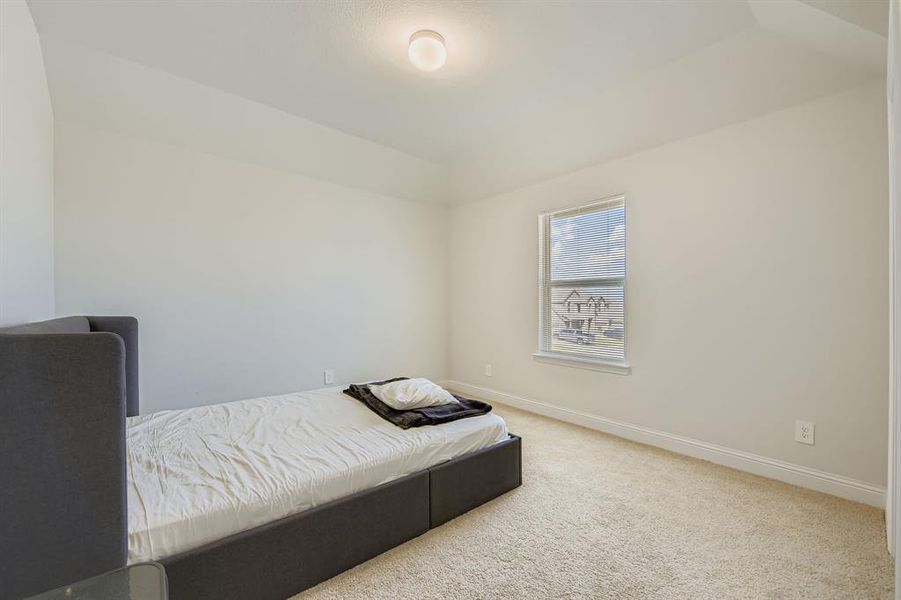 Carpeted bedroom with baseboards Carpeted bedroom with baseboards