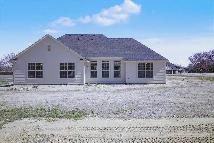 Rear view of property featuring roof with shingles