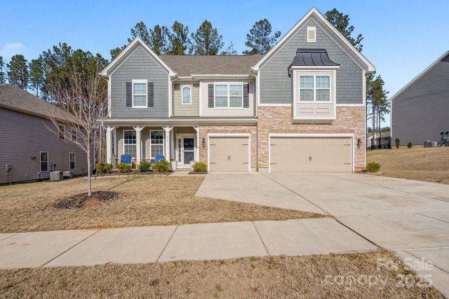 Front exterior of a new home in Falls Cove, Troutman, NC, highlighting curb appeal (Image 1). Front exterior of a new home in Falls Cove, Troutman, NC, highlighting curb appeal (Image 1).