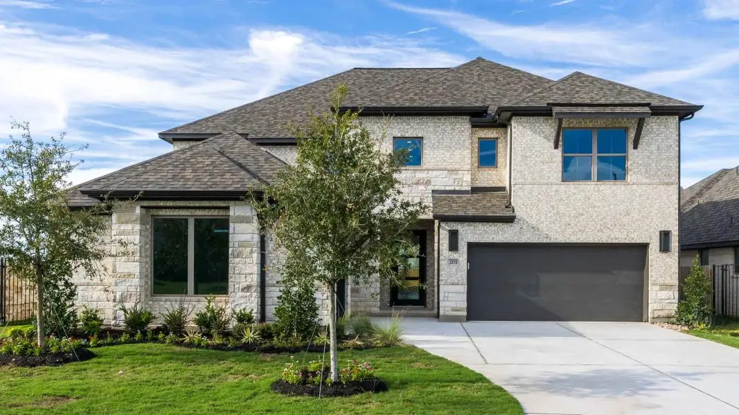 Front exterior of a new home in Santa Rita Ranch - Eldorado, Liberty Hill, TX, highlighting curb appeal (Image 1). Front exterior of a new home in Santa Rita Ranch - Eldorado, Liberty Hill, TX, highlighting curb appeal (Image 1).