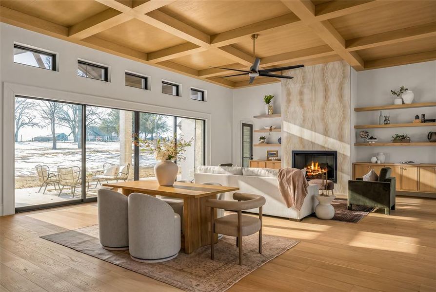 Expansive living area featuring light wood-finish flooring and a coffered ceiling