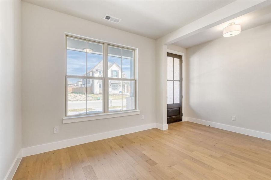 Empty room featuring light wood-type flooring and baseboards