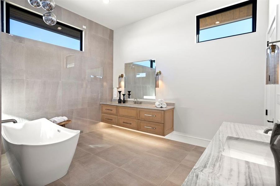 Separate his and her vanities and space for a sitting area.