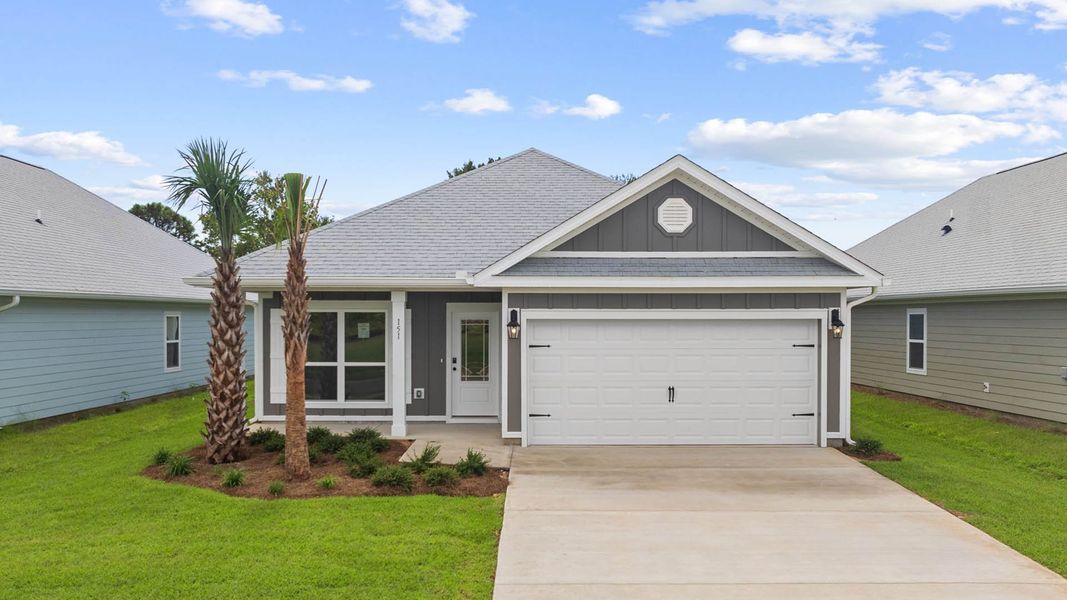 Front exterior of a new home in Caballeros Estates At Hombre, Panama City Beach, FL, highlighting curb appeal (Image 1).