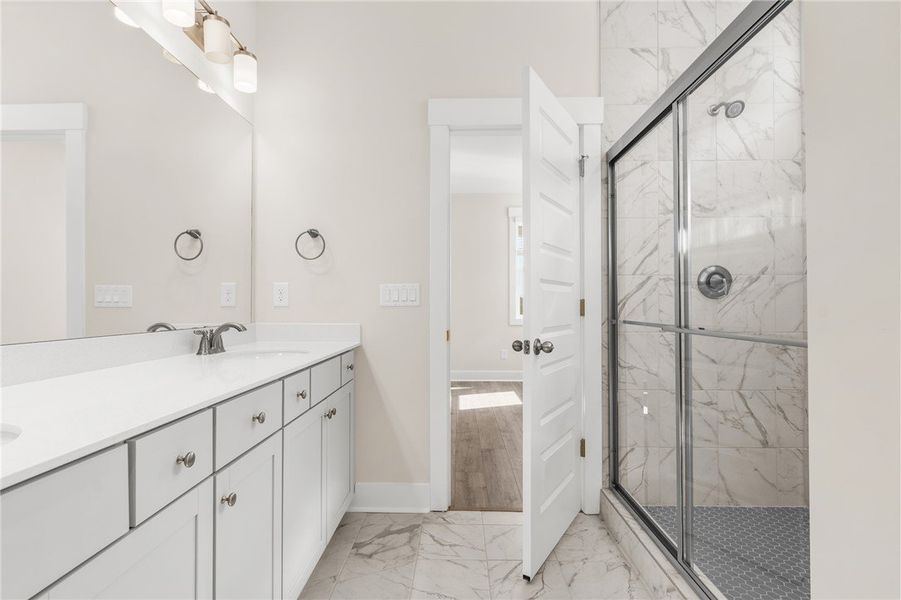 This spacious bathroom offers a double vanity and