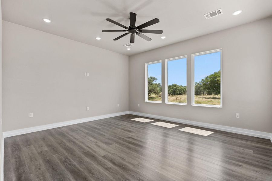 A spacious room with serene views of natural landscapes through multiple large windows. A spacious room with serene views of natural landscapes through multiple large windows.