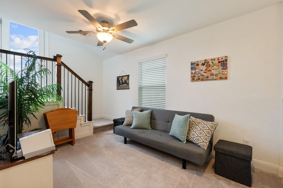 An inviting secondary living area features a soaring ceiling and a comfortable futon, ideal for relaxation. An inviting secondary living area features a soaring ceiling and a comfortable futon, ideal for relaxation.