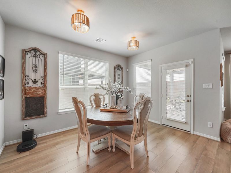 The dining area is filled with natural light and positioned perfectly for both intimate dinners and larger gatherings.