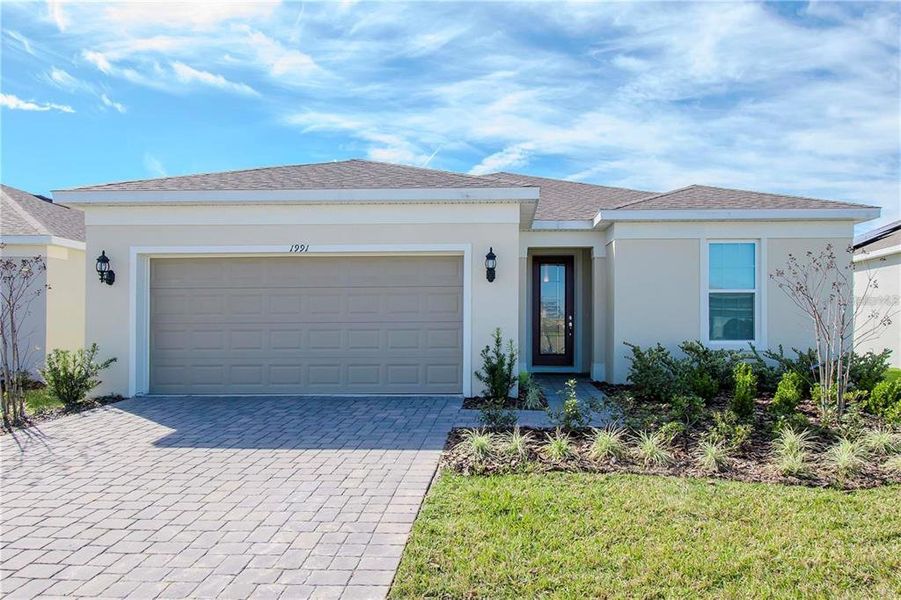 Front exterior of a new home in Tohoqua Reserve, Kissimmee, FL, highlighting curb appeal (Image 2).