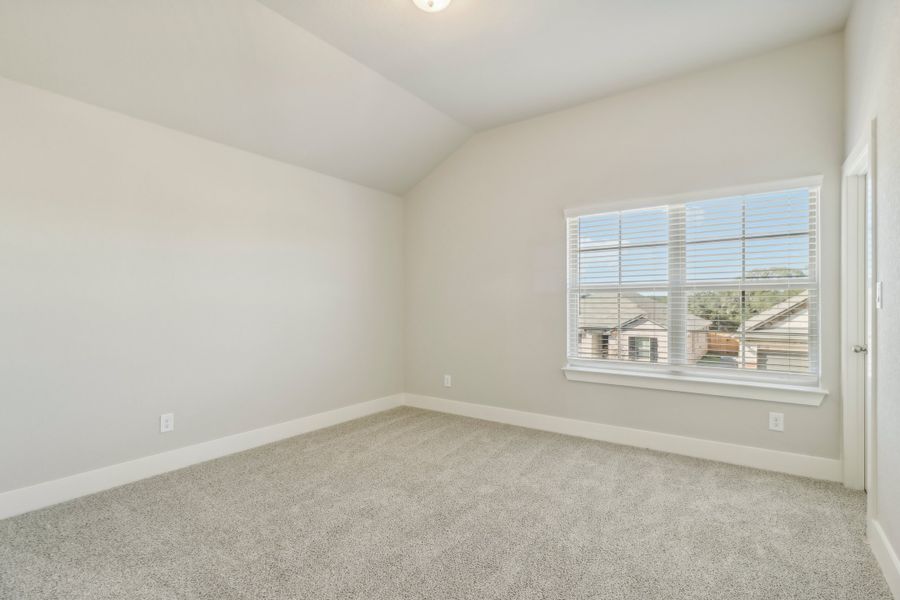 Guest bedroom in the Cedar floorplan at a Meritage Homes community.