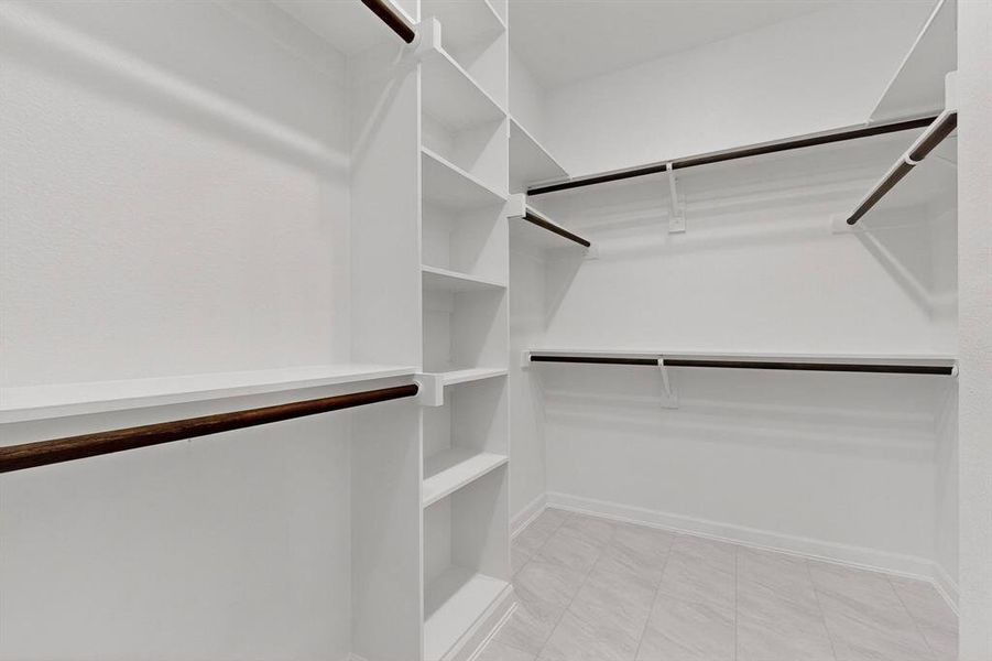 Walk in closet featuring light tile patterned floors Walk in closet featuring light tile patterned floors