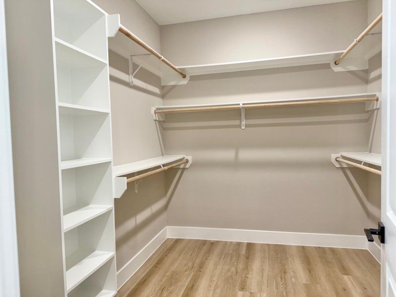 Spacious walk-in closet with ample shelving and hanging space for effortless organization.