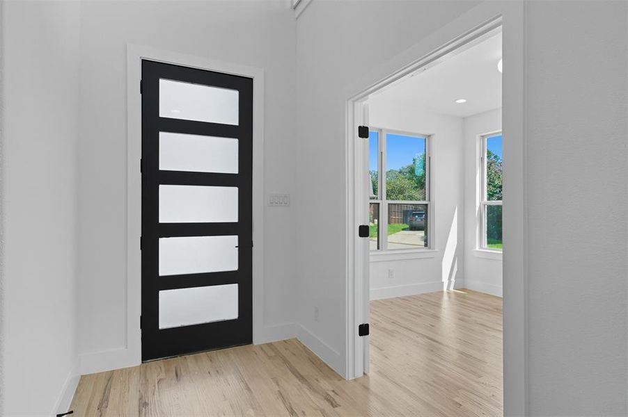 Foyer entrance featuring light wood-type flooring and baseboards