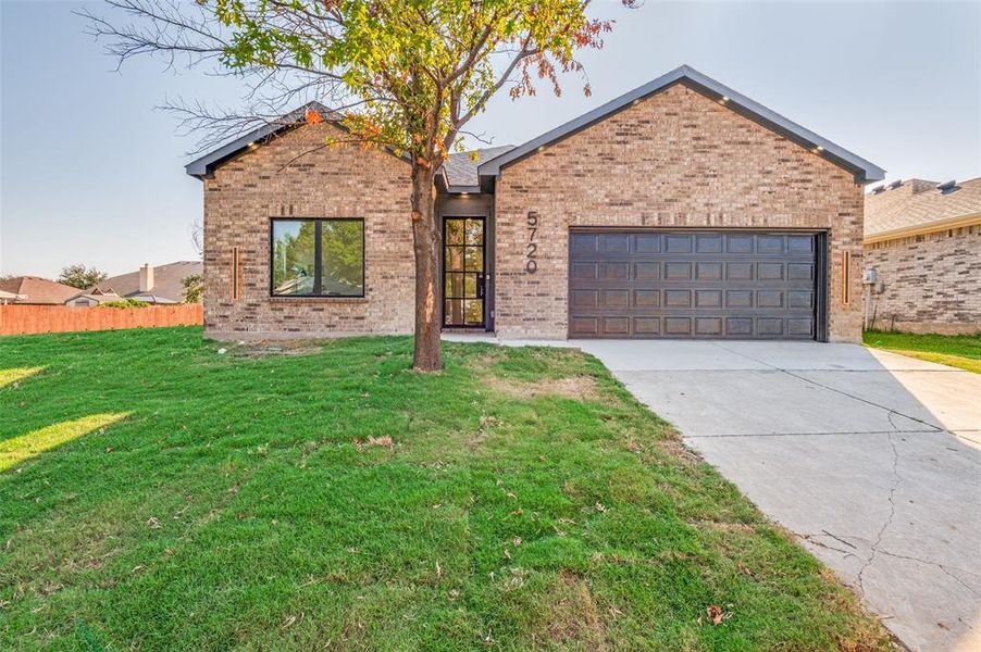 View of front facade with concrete driveway, brick siding, and a garage View of front facade with concrete driveway, brick siding, and a garage