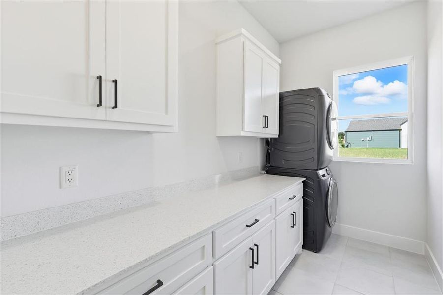 Laundry room with full size washer and dryer connections and built-in cabinets