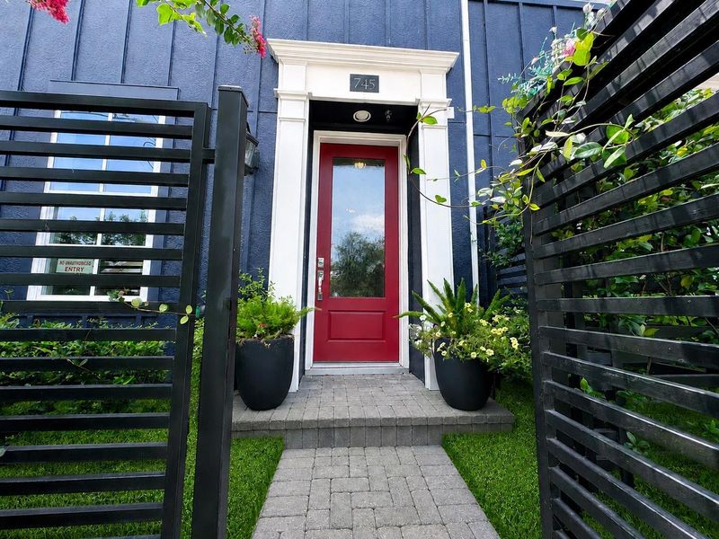 A privacy gate from the front sidewalk leads into a charming front porch. A privacy gate from the front sidewalk leads into a charming front porch.